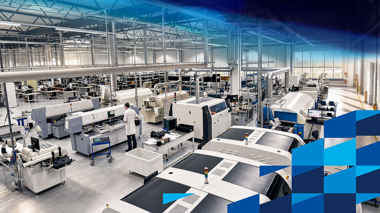 A production hall containing several production lines, workstations and machines in an industrial setting.