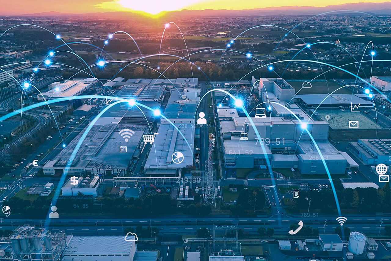 Aerial view of an industrial site featuring digital networking and data visualisations to manage complex production and site relocations.